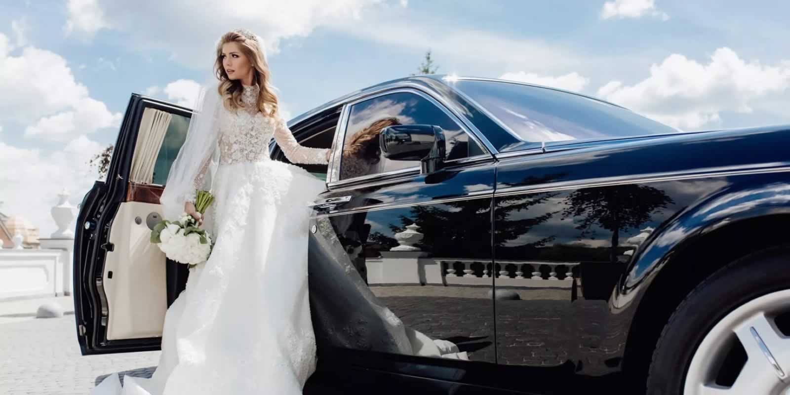 Bride steps out of a Rolls-Royce wedding car