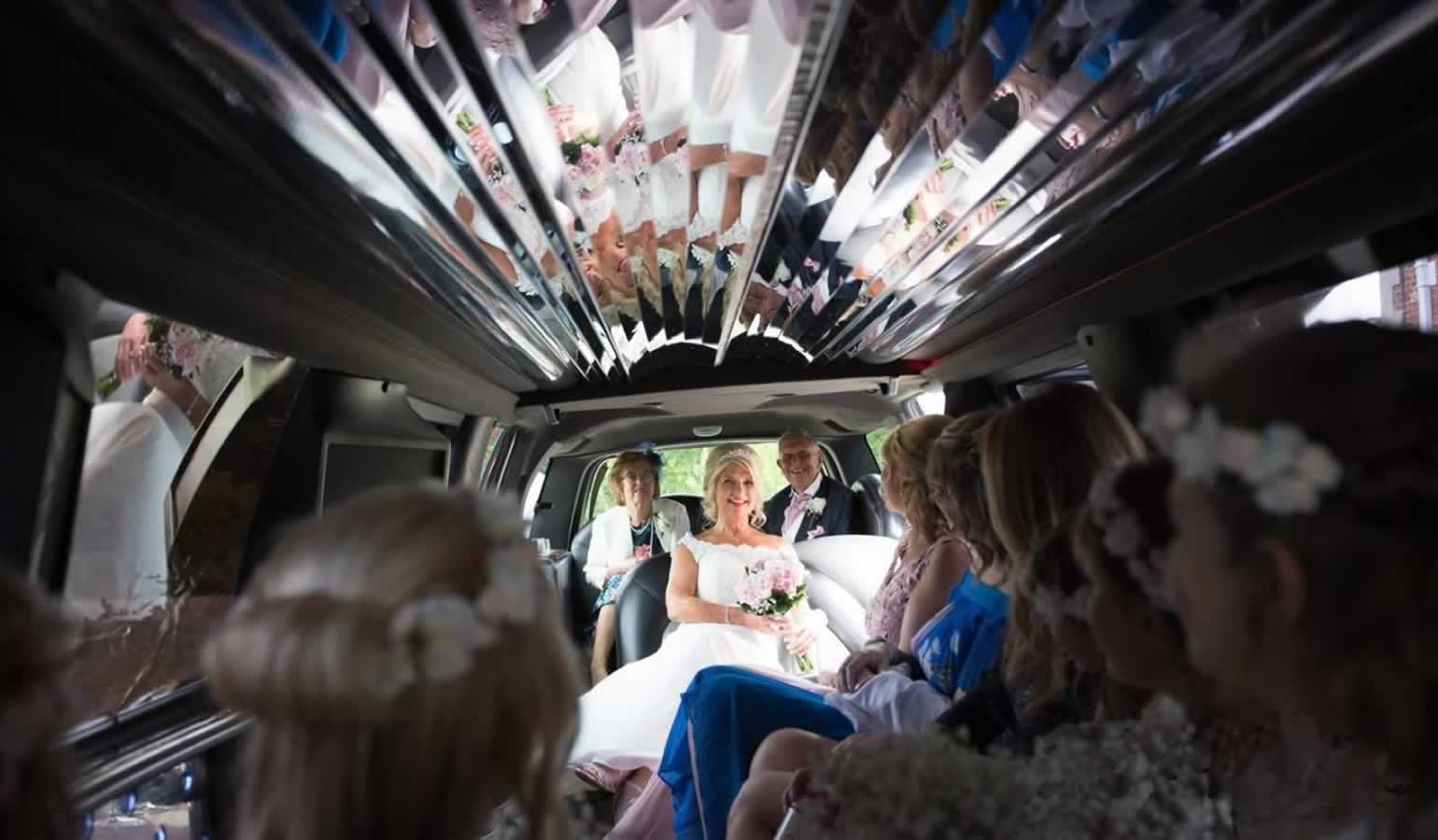 Wedding party inside an American SUV stretch limo