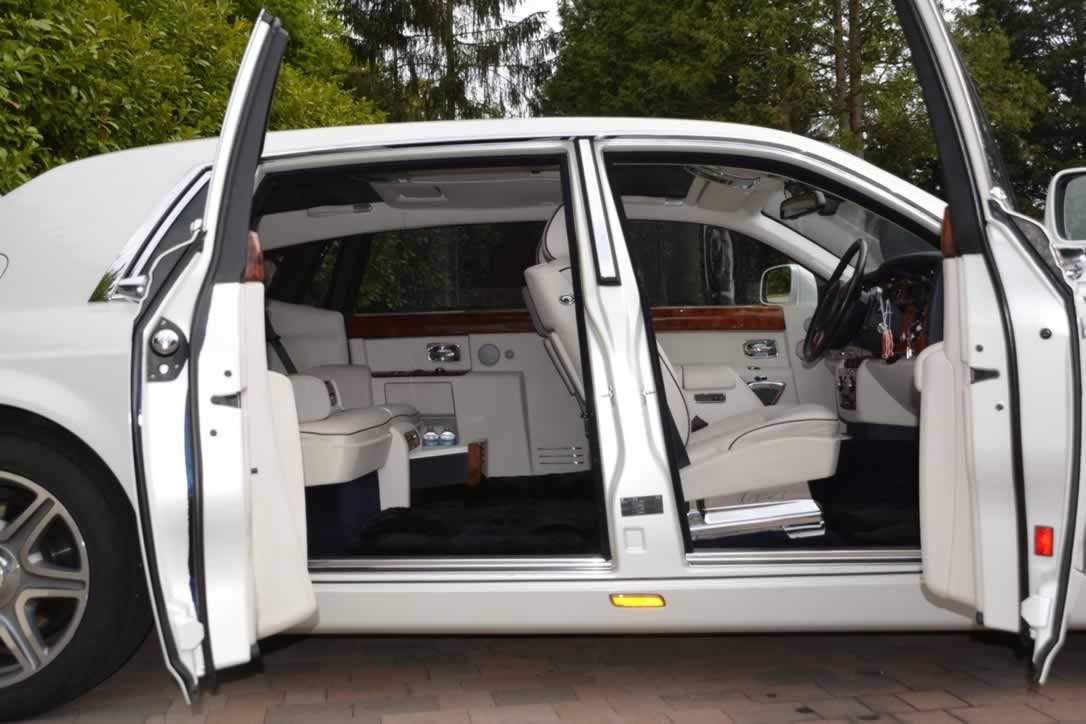Rolls-Royce Phantom II doors open showing white leather interior