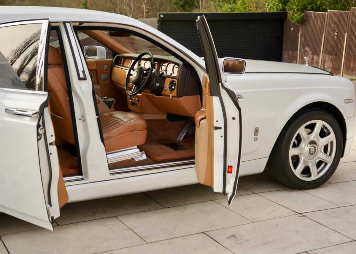 White Rolls-Royce Phantom Series I open door showing tan interior