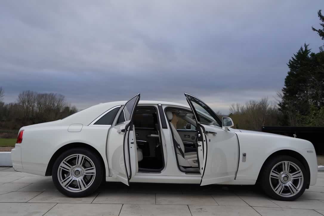 White Rolls-Royce Ghost side view with open doors showing interior