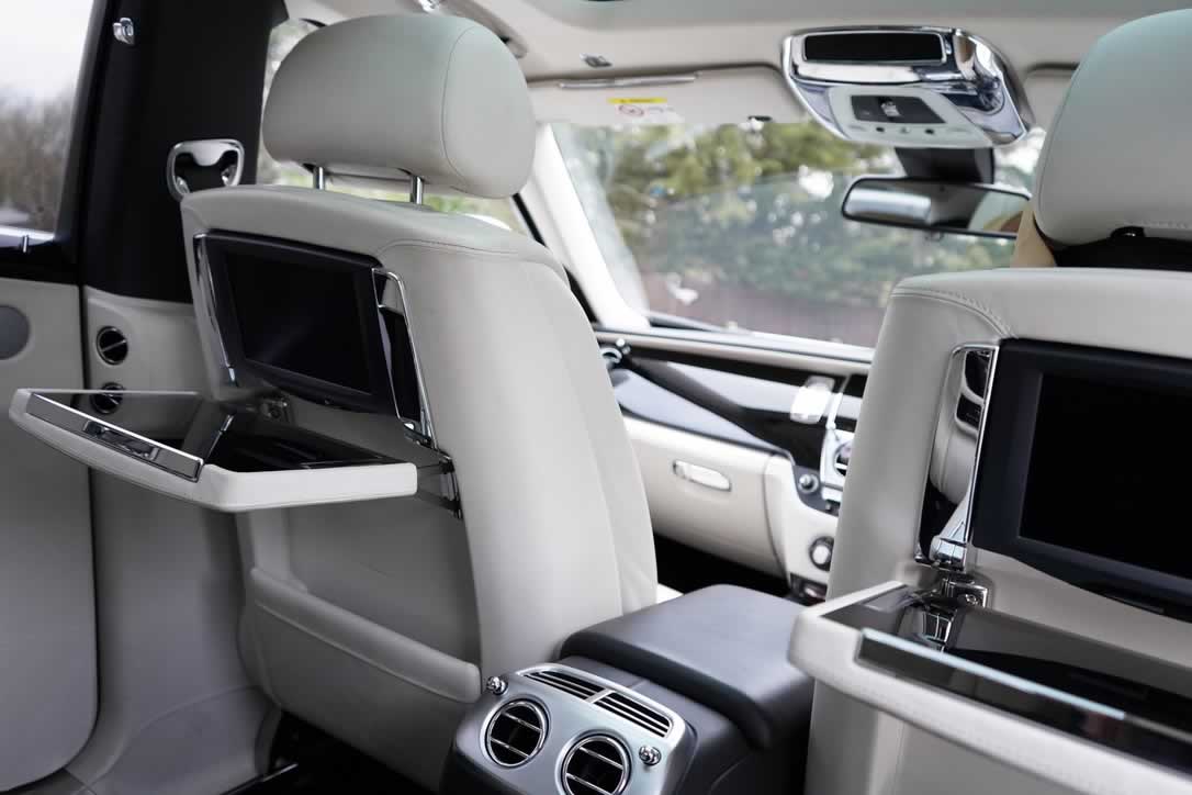 White Rolls-Royce Ghost interior rear cabin picnic tables behind front seats